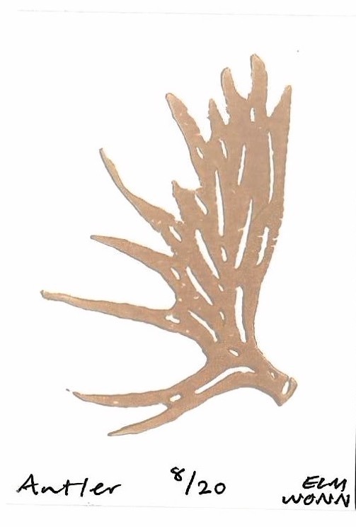A stag antler stamped in warm brown ink